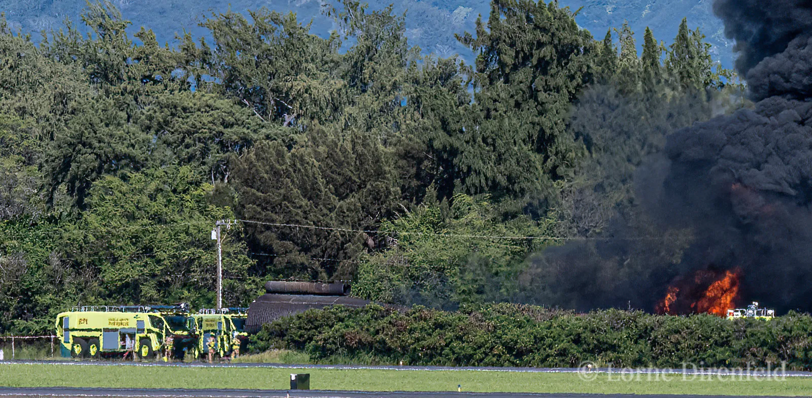 Aircraft rescue and firefighting (ARFF) team practicing extinguishing a fire in a mock airplane fuselage at Kahului airport . . .