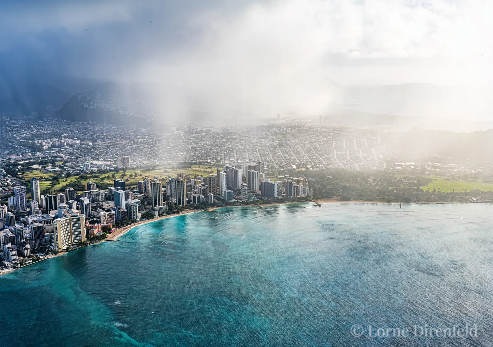 A morning shower on land, with clear skies and blue water off shore . . .
