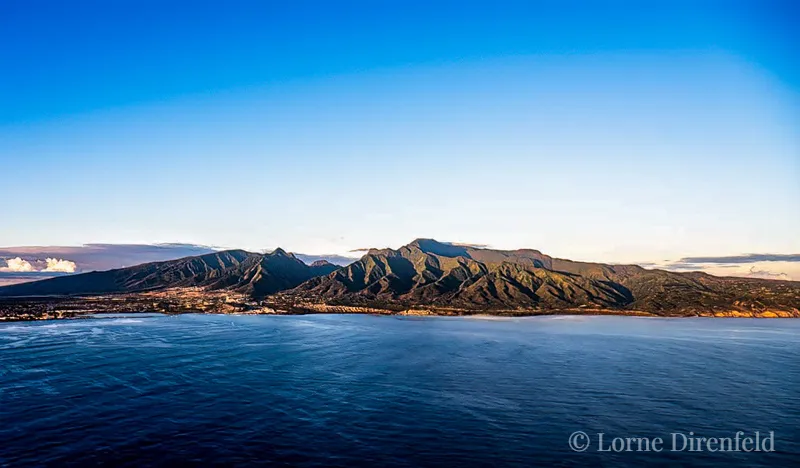 The early morning light outlines the ridges and valleys of west Maui, with Iao Valley just left of center, above the town of Wailuku . . .
