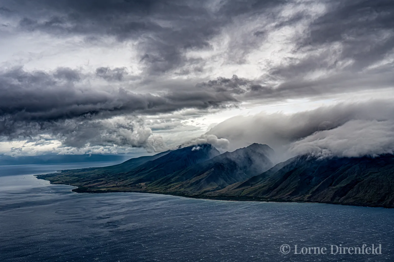 Clouds fill Oluwalu Valley and the wind is kicking up the waves . . .
